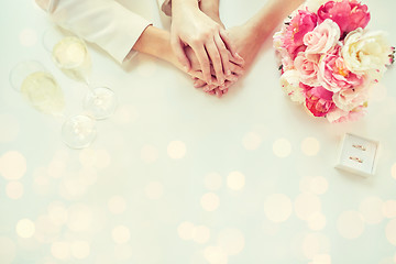 Image showing close up of lesbian couple hands and wedding rings