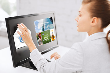 Image showing woman with web pages on touchscreen in office