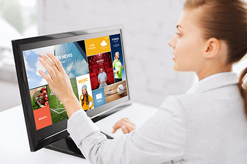 Image showing woman with web pages on touchscreen in office