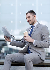 Image showing young businessman with coffee and newspaper