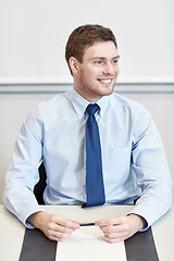 Image showing smiling businessman sitting in office