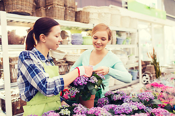 Image showing happy women choosing flowers in greenhouse