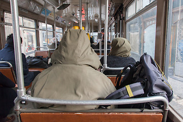 Image showing Man in winter coat sitting in tram