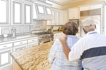 Image showing Senior Couple Looking Over Custom Kitchen Design Drawing and Pho