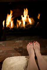 Image showing Warming toes by the fire