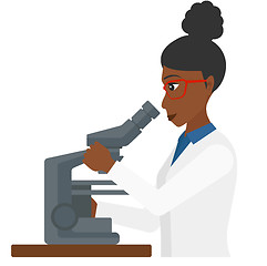 Image showing Laboratory assistant with microscope.