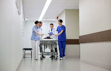 Image showing medics and patient on hospital gurney at emergency