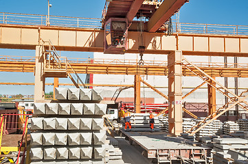 Image showing Slinger on workplace. Loading of products. Crane works