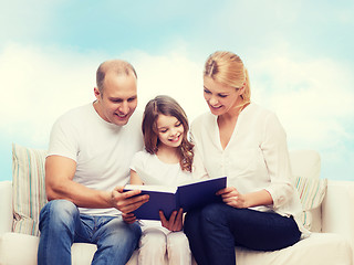 Image showing happy family with book at home