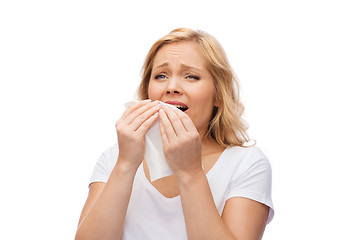 Image showing unhappy woman with paper napkin sneezing