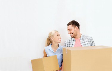 Image showing couple with delivery boxes moving to new home