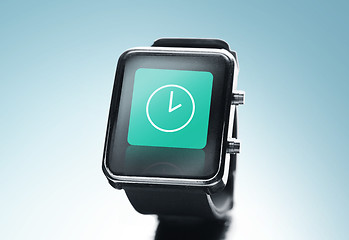 Image showing close up of black smart watch with clock icon