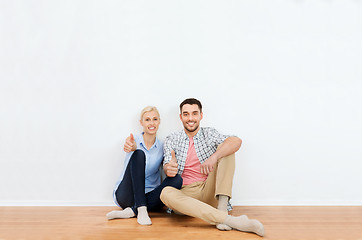 Image showing happy couple showing thumbs up at new home