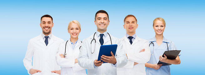 Image showing group of doctors with tablet pc and clipboard