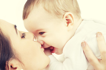 Image showing happy mother kissing baby boy