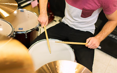 Image showing close up of male musician playing on drum kit