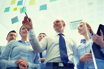 Image showing smiling business people with marker and stickers