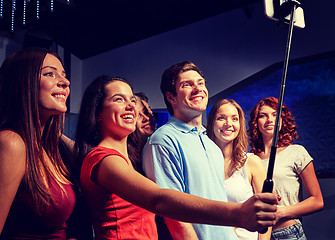 Image showing friends with smartphone taking selfie in club