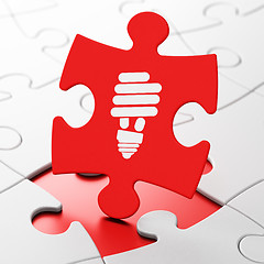 Image showing Business concept: Energy Saving Lamp on puzzle background