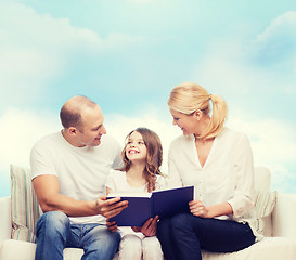 Image showing happy family with book at home