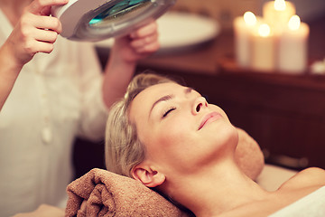 Image showing close up of young woman lying in spa