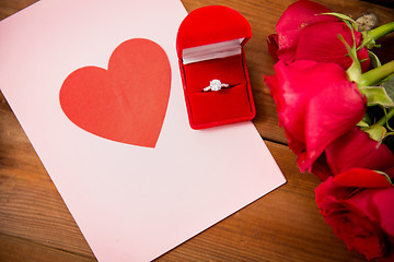 Image showing close up of diamond ring, roses and greeting card