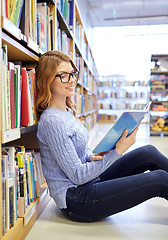 Image showing happy student girl reading book in library