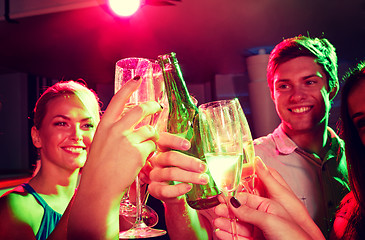 Image showing smiling friends with wine glasses and beer in club