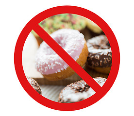 Image showing close up of glazed donuts pile behind no symbol