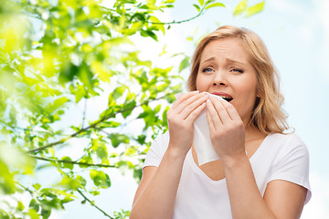 Image showing unhappy woman with paper napkin sneezing