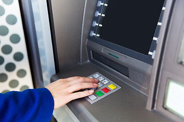 Image showing close up of hand entering pin code at cash machine