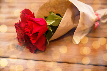 Image showing close up of red roses bunch wrapped into paper