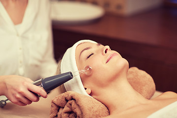 Image showing close up of young woman having face massage in spa