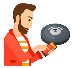 Image showing Man with robot vacuum cleaner.