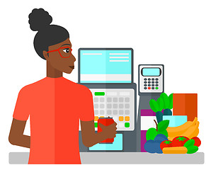 Image showing Cashier at supermarket checkout.