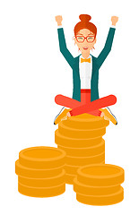 Image showing Happy business woman sitting on coins.