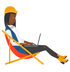 Image showing Business woman sitting in chaise lounge with laptop.