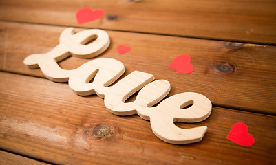 Image showing close up of word love with red paper hearts