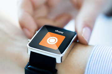 Image showing close up of hands setting smartwatch