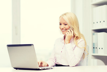 Image showing smiling businesswoman calling on smartphone