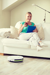 Image showing happy woman with tablet pc drinking tea at home