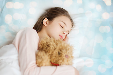 Image showing girl sleeping with teddy bear toy in bed