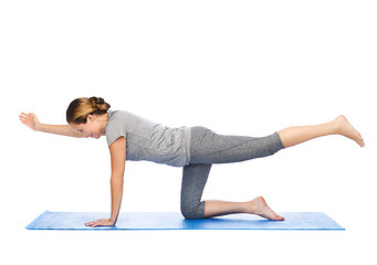 Image showing woman making yoga in balancing table pose on mat