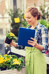 Image showing happy woman with tablet pc in greenhouse
