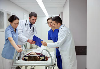 Image showing medics and patient on hospital gurney at emergency