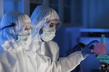 Image showing close up of scientists making test in chemical lab