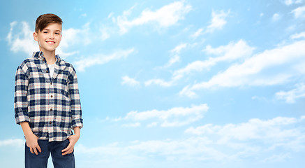 Image showing smiling boy in checkered shirt and jeans