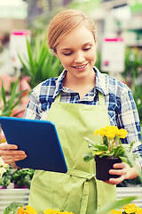 Image showing happy woman with tablet pc in greenhouse