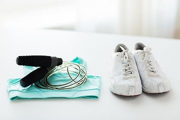 Image showing close up of sports top, sneakers and skipping rope