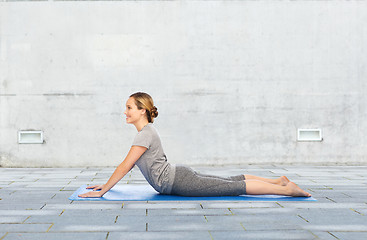 Image showing woman making yoga in dog pose on mat